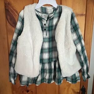 Girls plaid top and fuzzy vest.